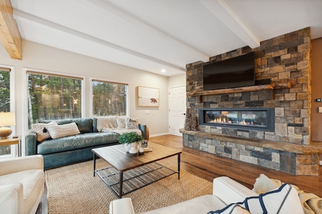 living room with beam ceiling, a fireplace, and hardwood / wood-style floors