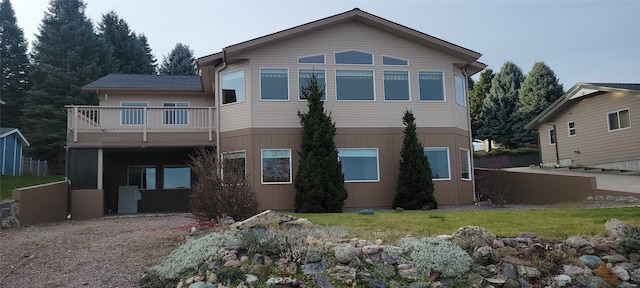 back of property featuring a balcony