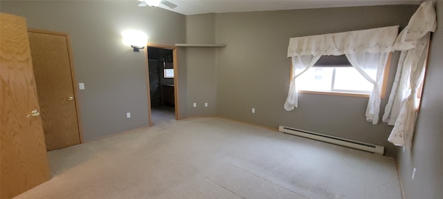 carpeted empty room featuring ceiling fan and baseboard heating