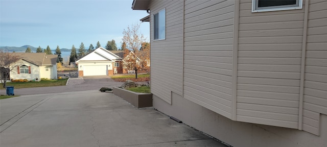 view of property exterior with a mountain view and an outbuilding