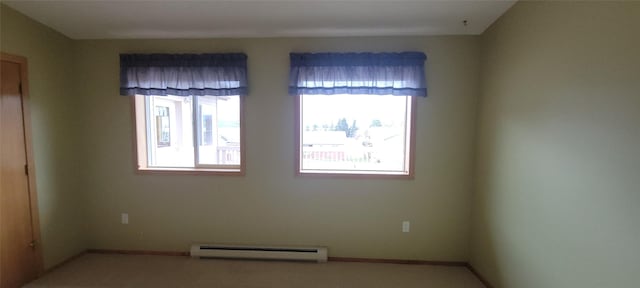 unfurnished room with baseboards, baseboard heating, and plenty of natural light