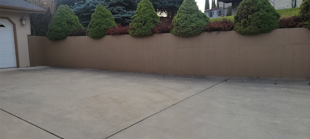 exterior space featuring a garage and fence