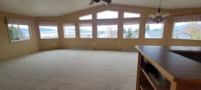 unfurnished dining area with carpet flooring, a healthy amount of sunlight, and a baseboard heating unit