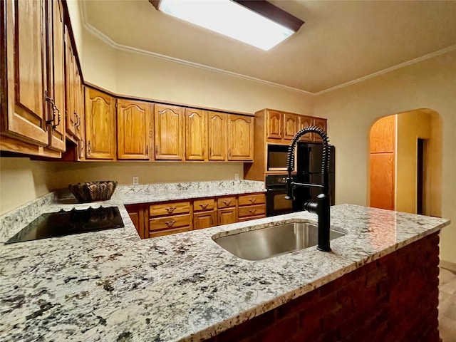 kitchen with sink, crown molding, black electric cooktop, light stone counters, and kitchen peninsula