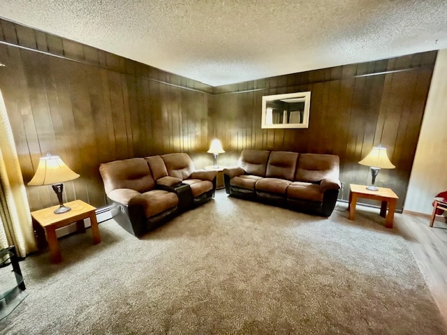 cinema room with carpet flooring, a textured ceiling, and wood walls