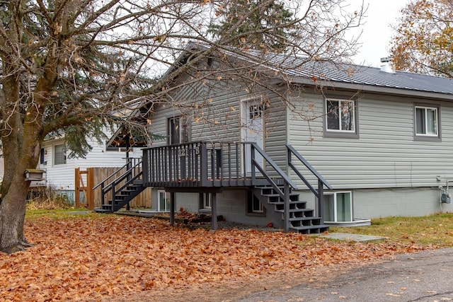 121 Mill Ave, Whitefish, MT 59937 - back of property featuring stairs, a chimney, and a wooden deck