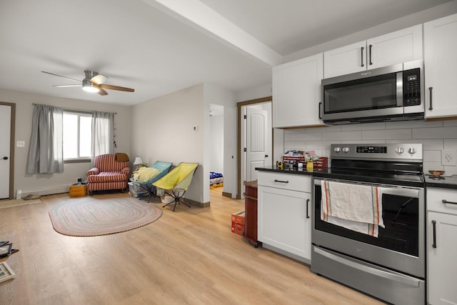 121 Mill Ave, Whitefish, MT 59937 - kitchen featuring stainless steel appliances, open floor plan, tasteful backsplash, a ceiling fan, and dark countertops