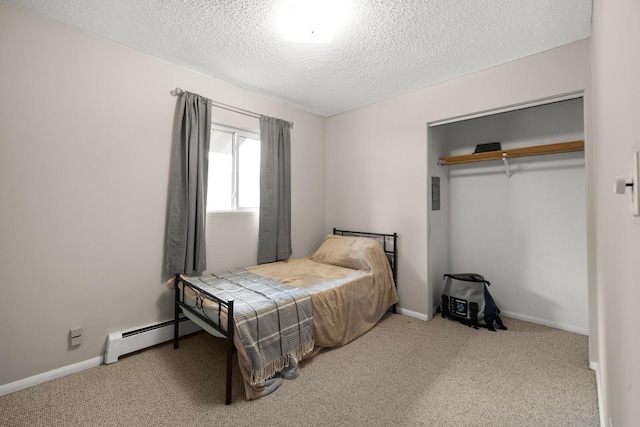 121 Mill Ave, Whitefish, MT 59937 - bedroom featuring a baseboard radiator, a textured ceiling, carpet, and a closet