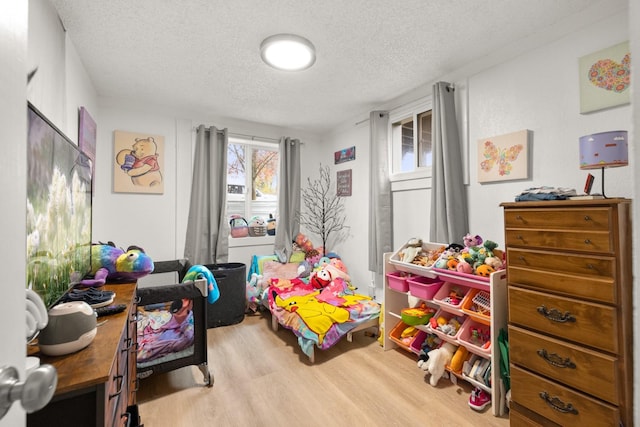 121 Mill Ave, Whitefish, MT 59937 - playroom with wood finished floors and a textured ceiling