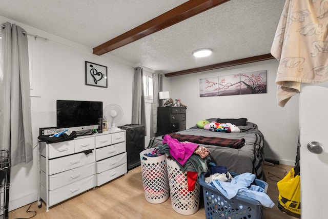 121 Mill Ave, Whitefish, MT 59937 - bedroom with a textured ceiling, light wood-style floors, and beam ceiling