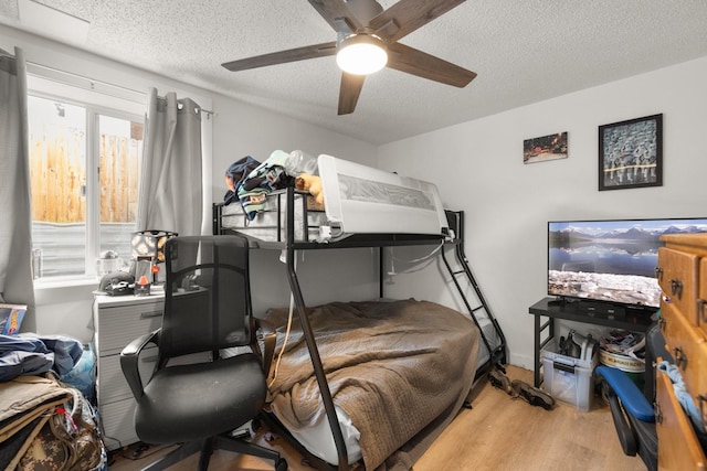 121 Mill Ave, Whitefish, MT 59937 - bedroom with wood finished floors, a textured ceiling, a desk, and a ceiling fan