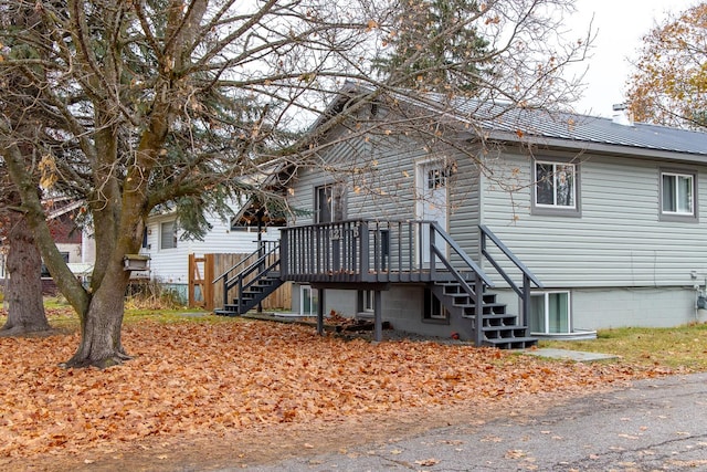 121 Mill Ave, Whitefish, MT 59937 - view of front of home with stairs, a wooden deck, and a chimney