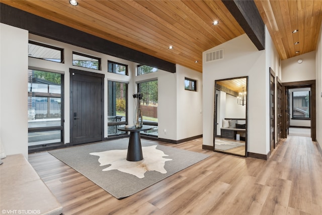 entryway with high vaulted ceiling, wood ceiling, and light wood-type flooring