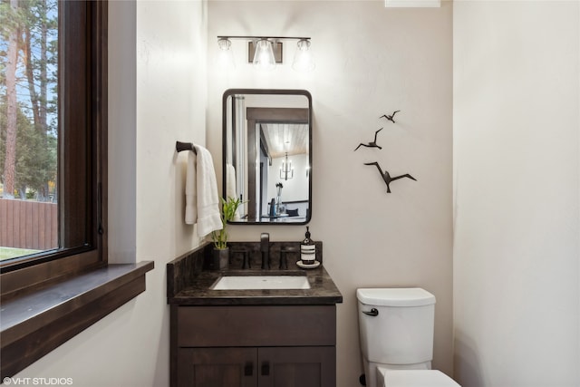 bathroom featuring vanity and toilet