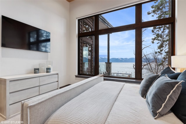 bedroom with a water and mountain view