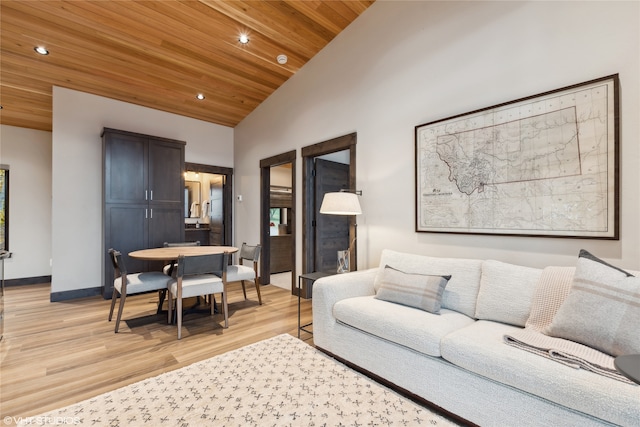 living room featuring light hardwood / wood-style floors, wooden ceiling, and high vaulted ceiling