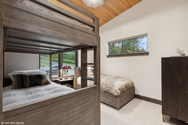 bedroom with light carpet, wood ceiling, and lofted ceiling