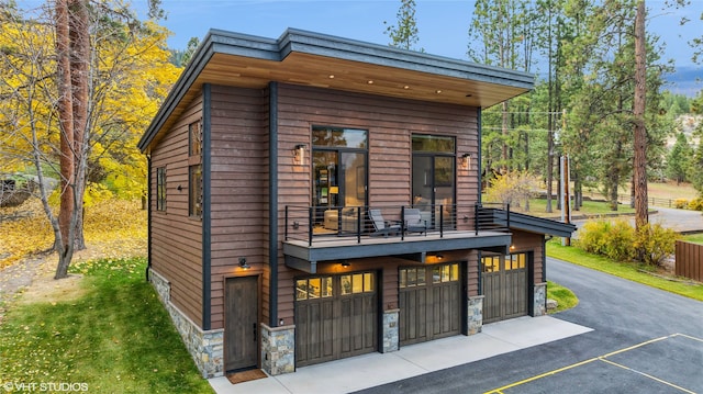 exterior space with a balcony and a garage