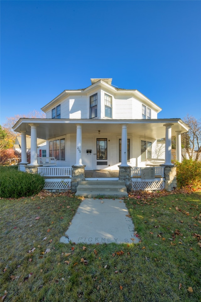 view of front facade with covered porch and a front lawn