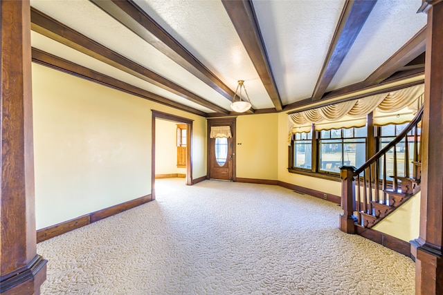 interior space featuring beam ceiling and a textured ceiling