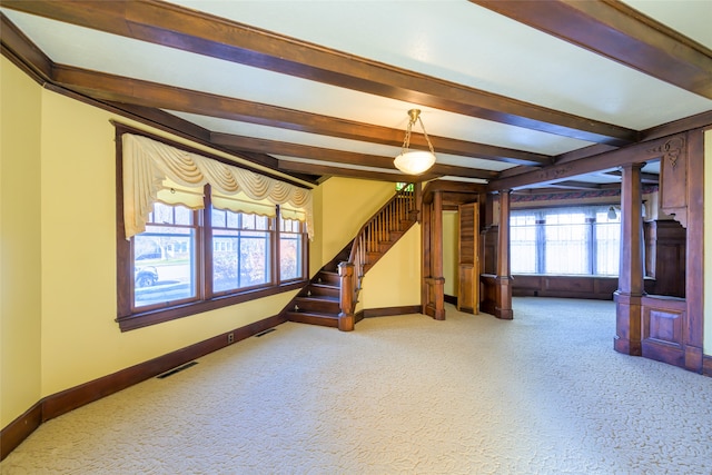 living room featuring beamed ceiling and carpet floors