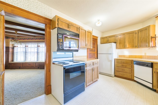 kitchen featuring beamed ceiling and white appliances