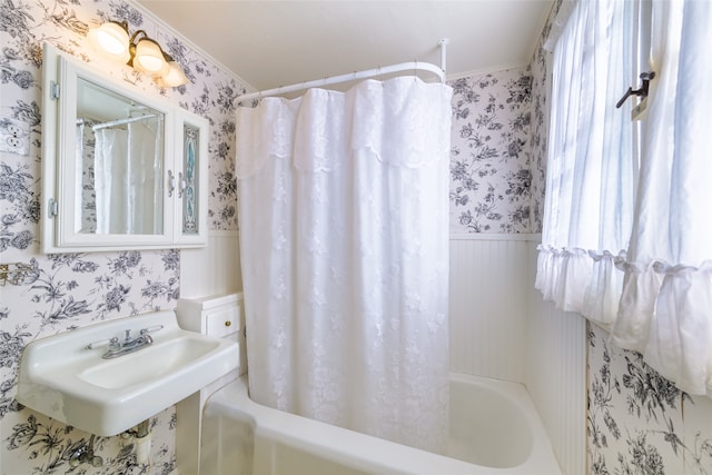 bathroom featuring sink and shower / bath combination with curtain