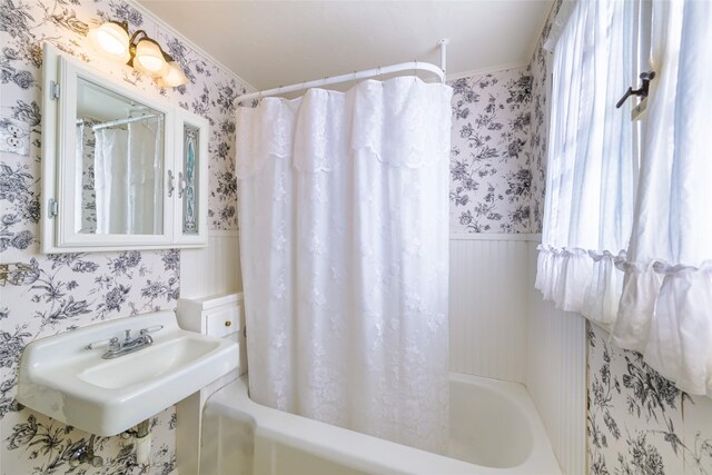 200 N 5th St, Hamilton, MT 59840 - bathroom featuring wallpapered walls, shower / tub combo with curtain, a wainscoted wall, and a sink
