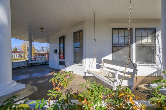 deck featuring radiator heating unit and covered porch