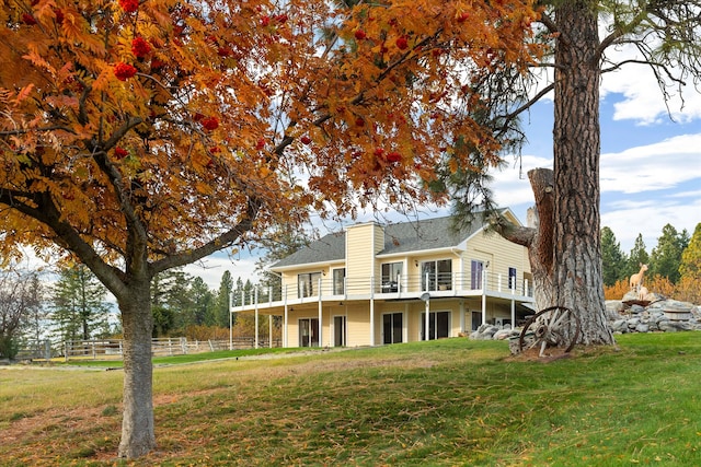 rear view of property with a yard