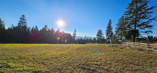 view of yard with a mountain view and a rural view