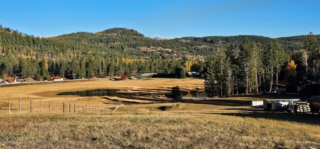 property view of mountains featuring a water view and a rural view