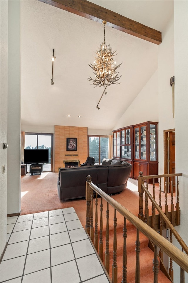 living room with beamed ceiling, carpet flooring, high vaulted ceiling, and a healthy amount of sunlight