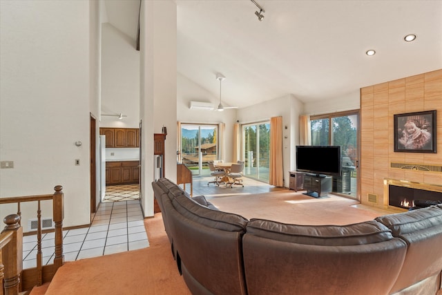 tiled living room with high vaulted ceiling and a tiled fireplace