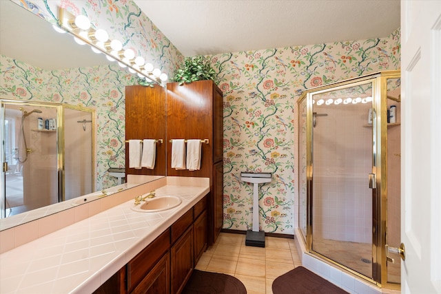 bathroom featuring tile patterned floors, vanity, and an enclosed shower