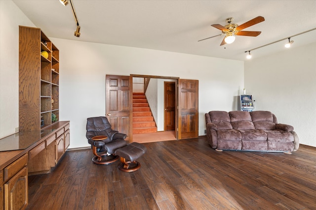 living room featuring rail lighting, ceiling fan, and dark wood-type flooring