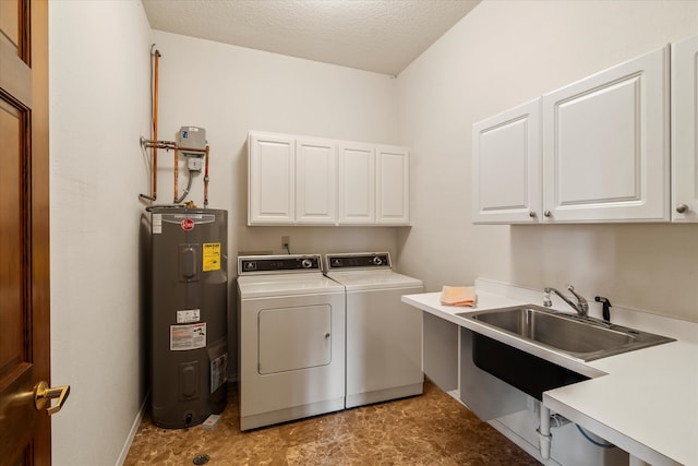 washroom with washing machine and clothes dryer, sink, cabinets, water heater, and a textured ceiling