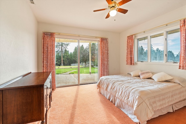 carpeted bedroom with access to outside, multiple windows, and ceiling fan