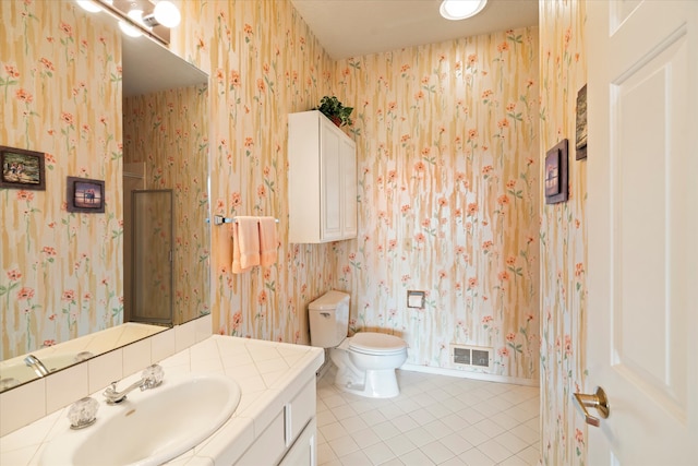 bathroom featuring tile patterned floors, vanity, and toilet