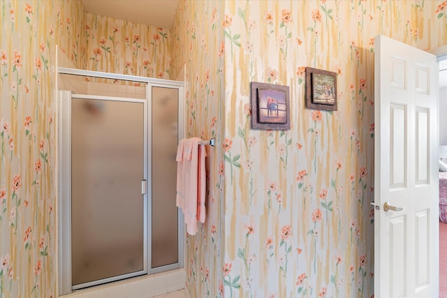 bathroom with a shower with shower door