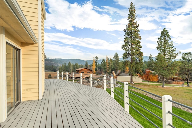 wooden terrace with a lawn and a mountain view