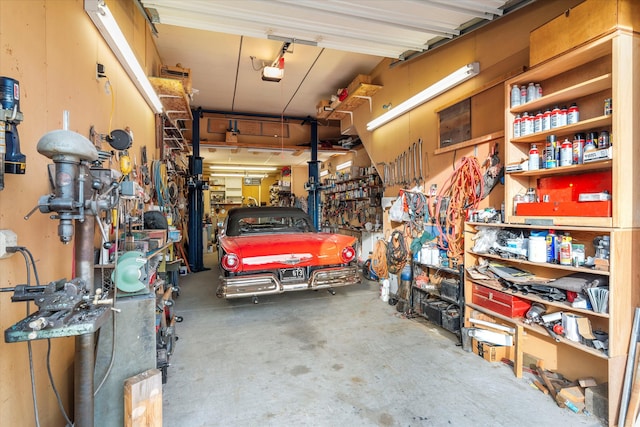 garage with a workshop area and a garage door opener