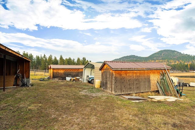 view of yard with a mountain view and an outdoor structure