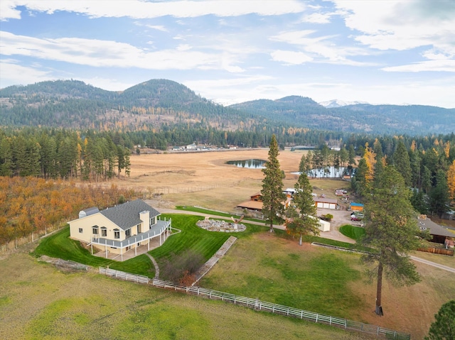 birds eye view of property with a water and mountain view and a rural view