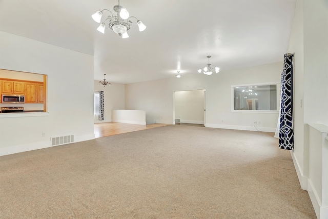 unfurnished living room featuring light carpet and a notable chandelier