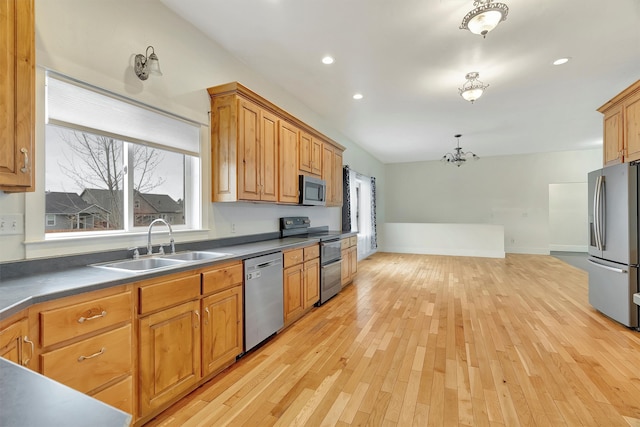 kitchen featuring sink, an inviting chandelier, light wood-type flooring, and appliances with stainless steel finishes