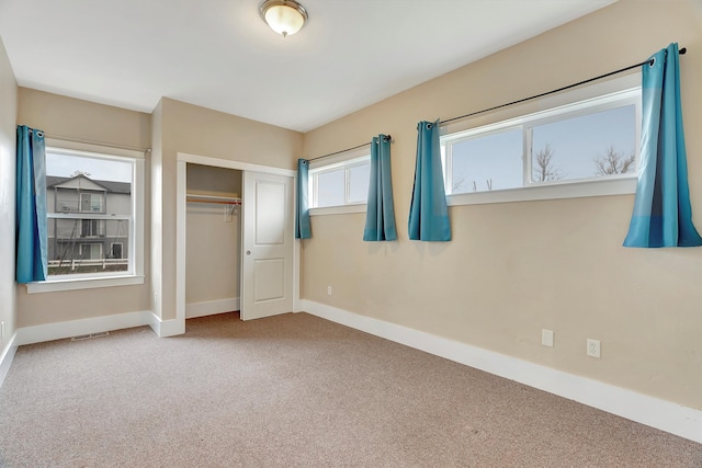 unfurnished bedroom featuring carpet and a closet