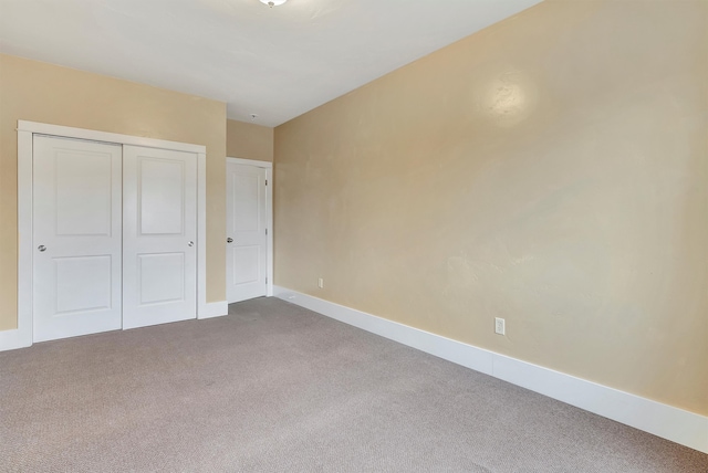 unfurnished bedroom featuring carpet flooring and a closet