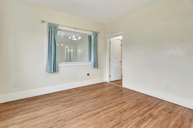 empty room with hardwood / wood-style flooring