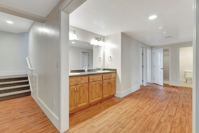 bathroom featuring vanity, hardwood / wood-style flooring, and toilet